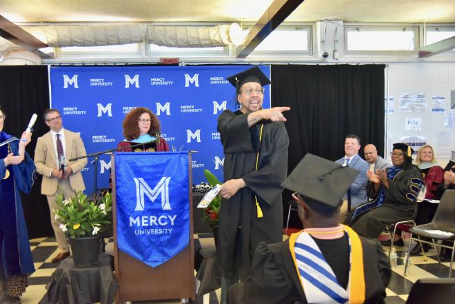 At the podium during the Mercy University commencement